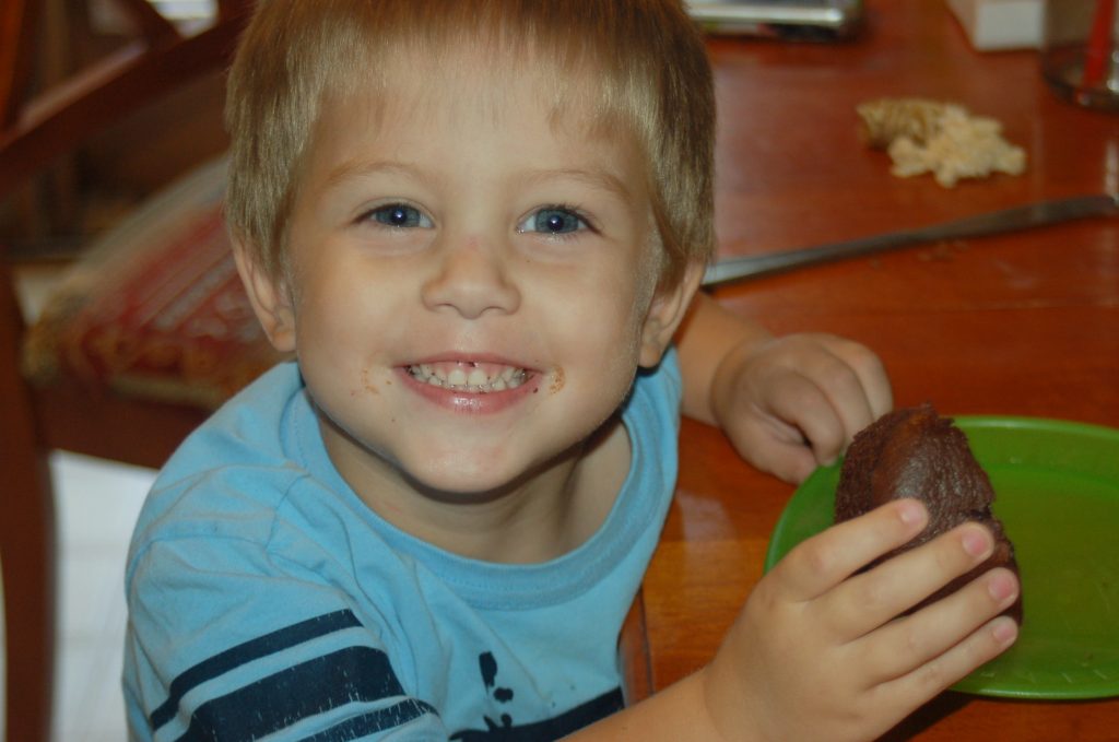 boy eating gluten free muffin