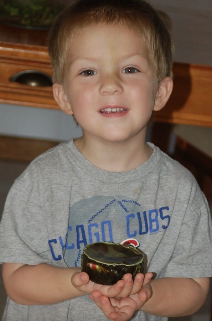 preschool boy holding his homemade soap