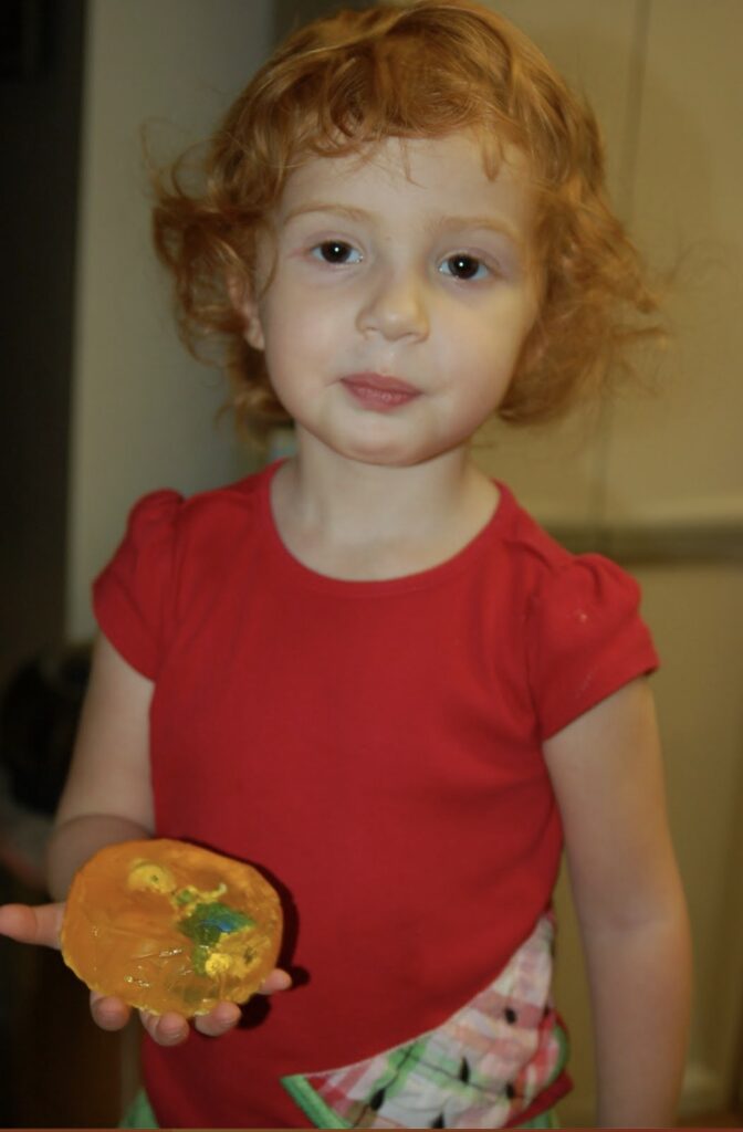 preschool girl holding her homemade soap