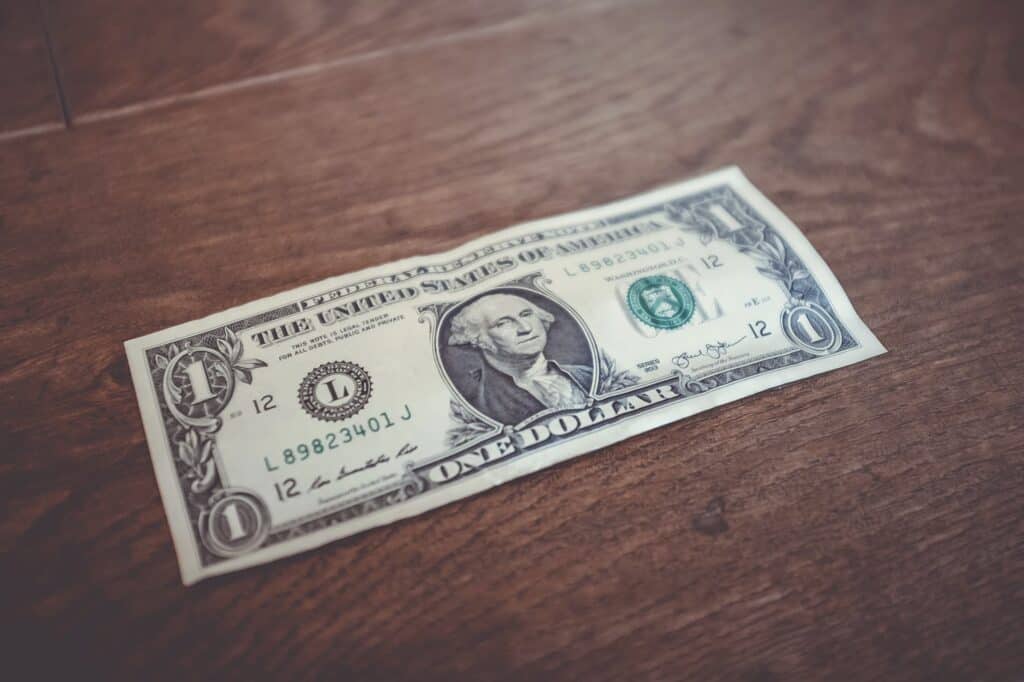dollar bill money on wood table