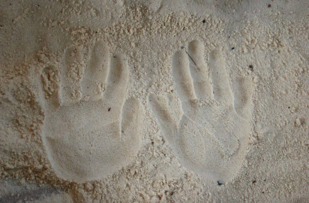 handprints in the sand