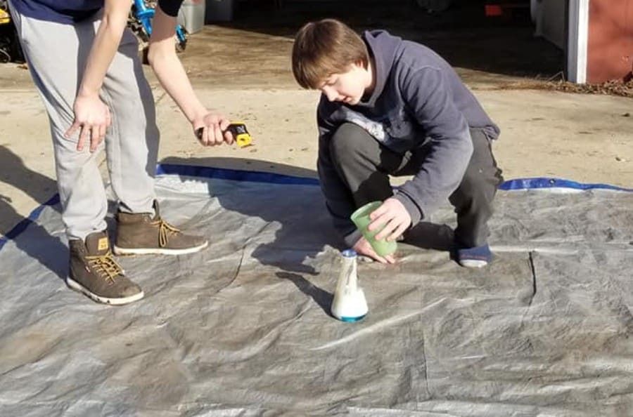 teenage boy doing science experiment