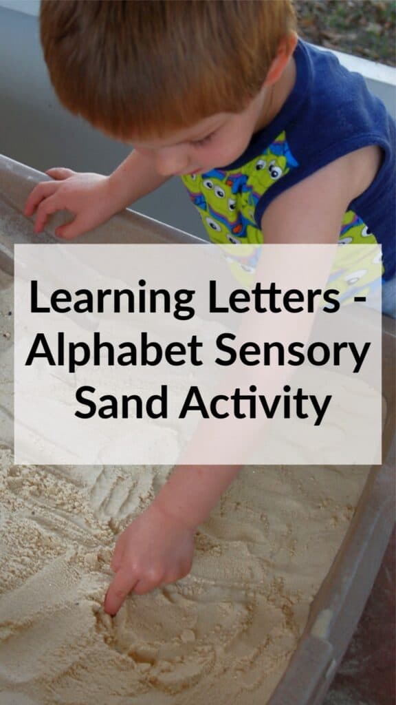 boy writing in sand