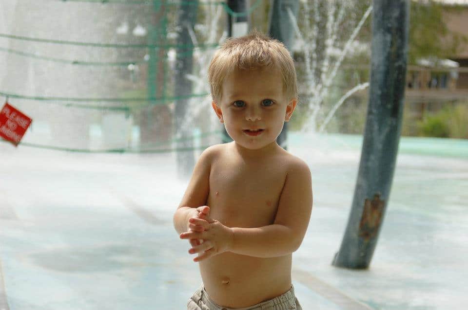 toddler boy playing in water