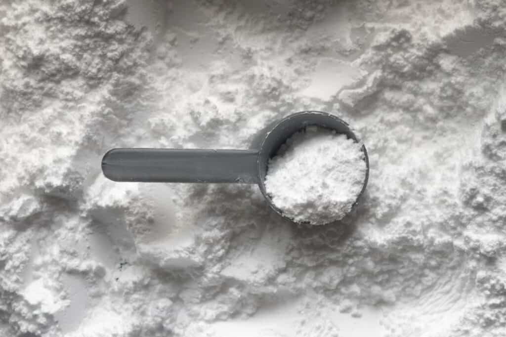 measuring cup of white powder