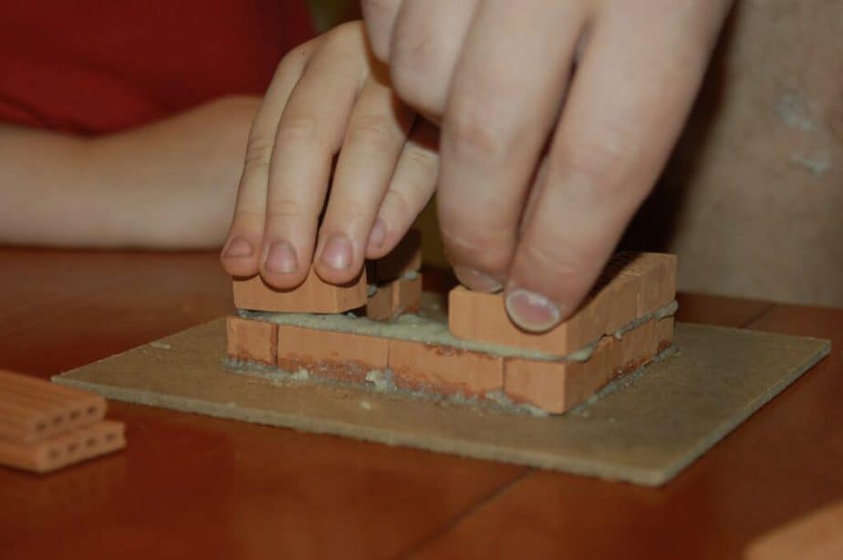 hands holding bricks
