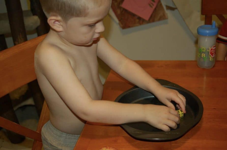 boy playing math game in pie pan