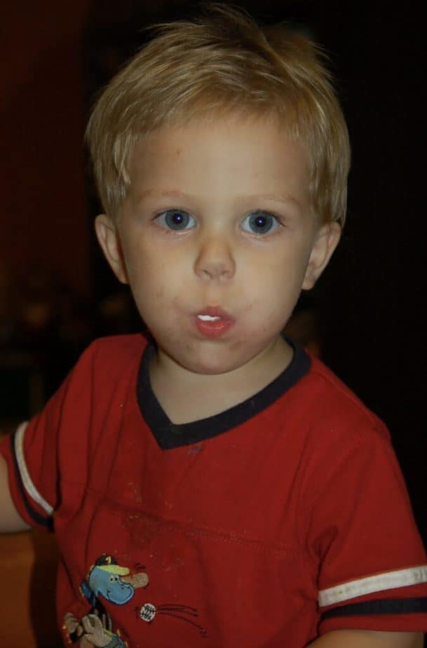 toddler boy with marshmallows in mouth