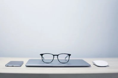 glasses laying on laptop 