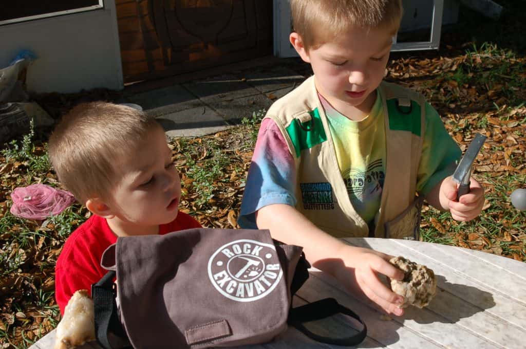 boy cracking geodes rocks