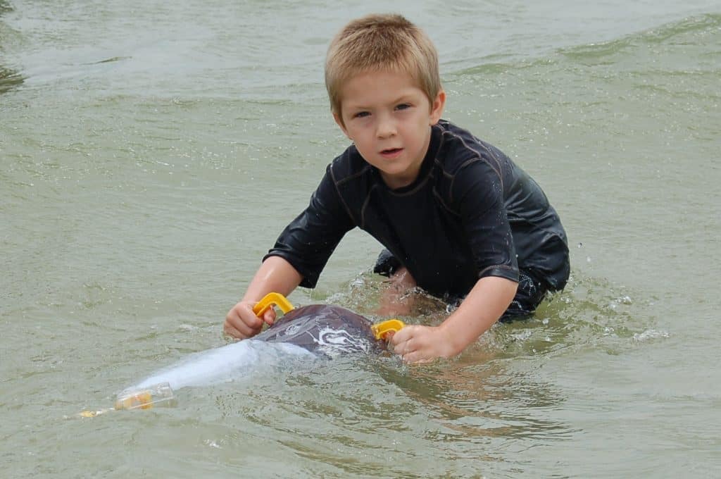 boy in ocean with plankton net