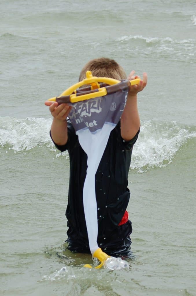 boy in ocean with plankton net