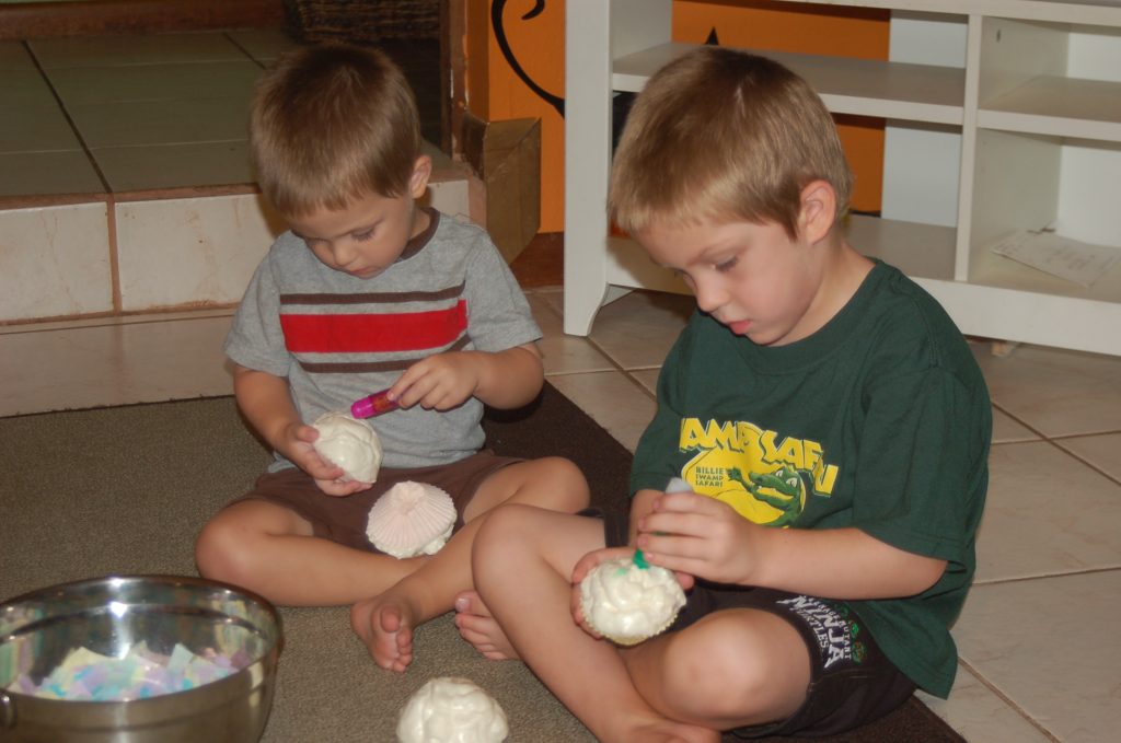 boys decorating cupcake craft with foam insulation