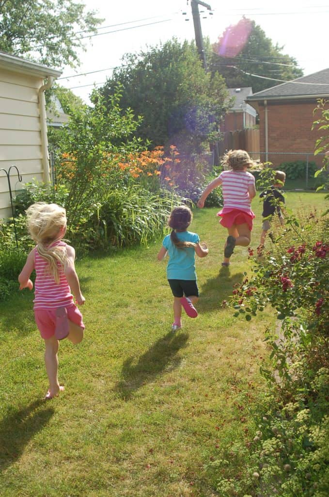 kids running through grassy yard