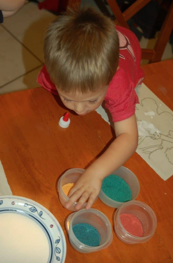 boy crafting with art sand