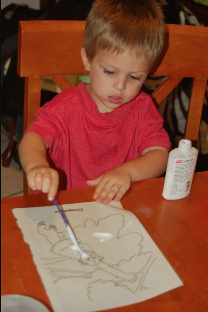 boy painting with glue