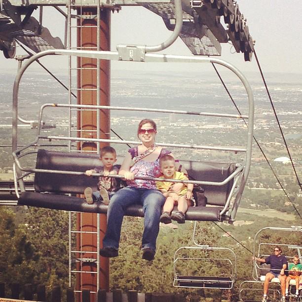 mom with two boys sitting on ski lift