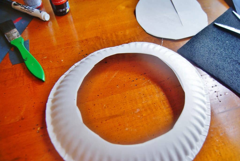 white paper plate with circle cut in middle