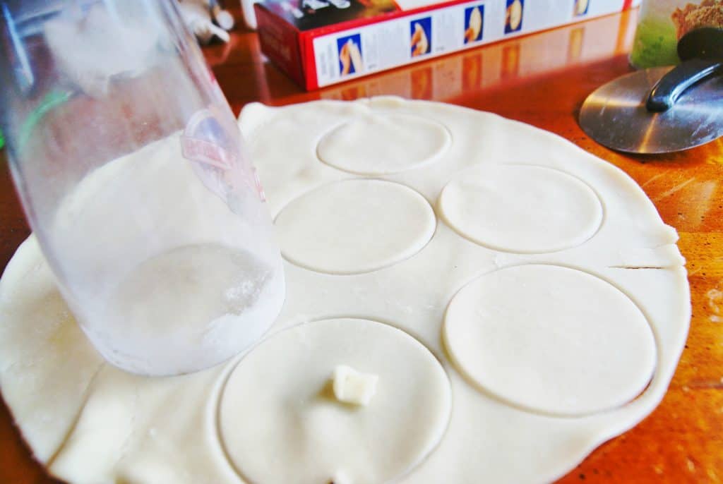 cutting raw dough for apple pie