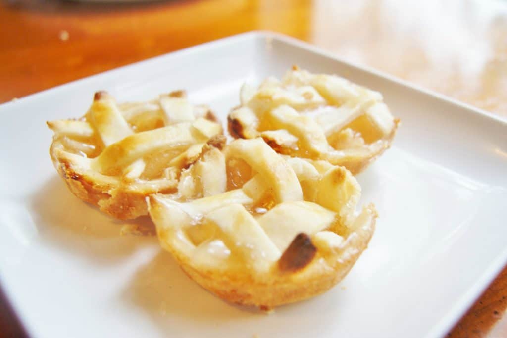 mini apple pies on white serving plate