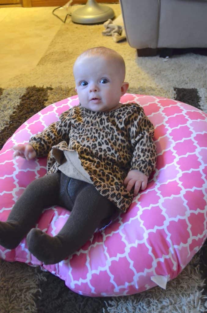 baby girl in a pink Boppy newborn lounger