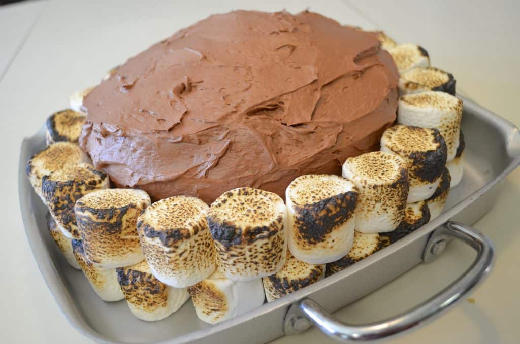 Adding a layer of marshmallows for campfire cake