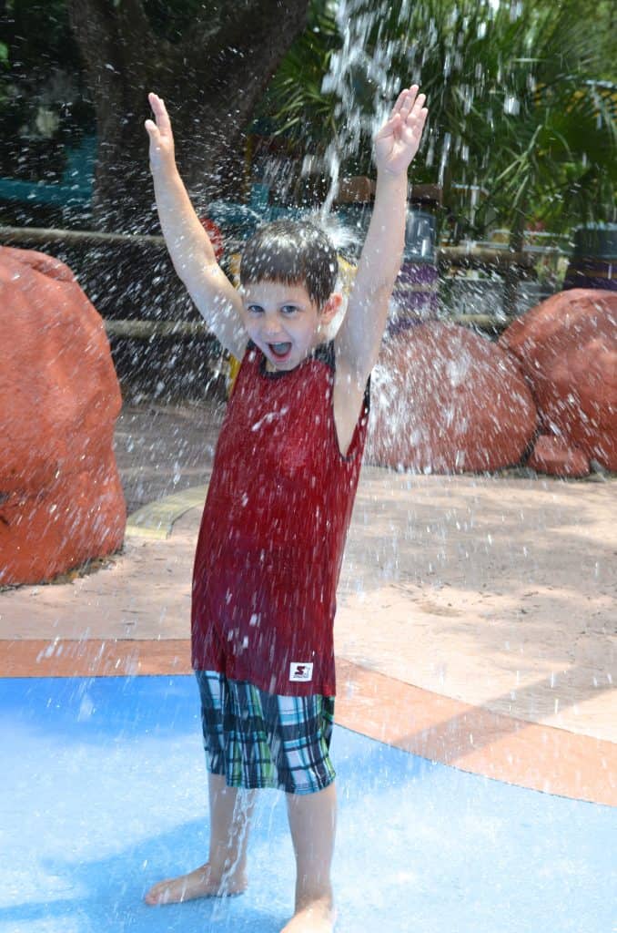 boy playing in splash water pad at Lowry Park Zoo