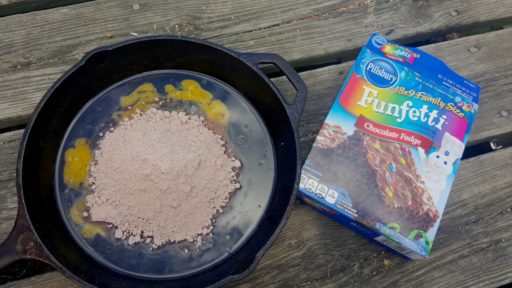 Brownies over the Campfire: Making Family Memories - Just cut a half of a Pillsbury Brownie Mix box in half, mix in your cast iron pan, and bake over the campfire!