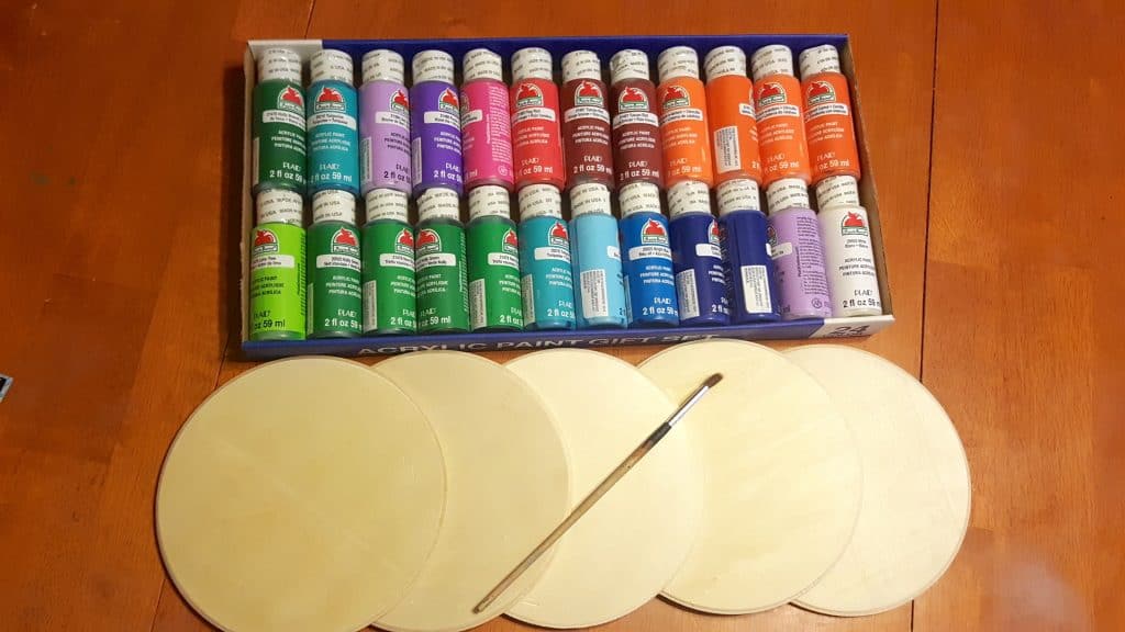 box of paint and wooden craft circles