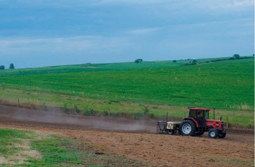 farming tractor plowing a field for a school butterfly garden