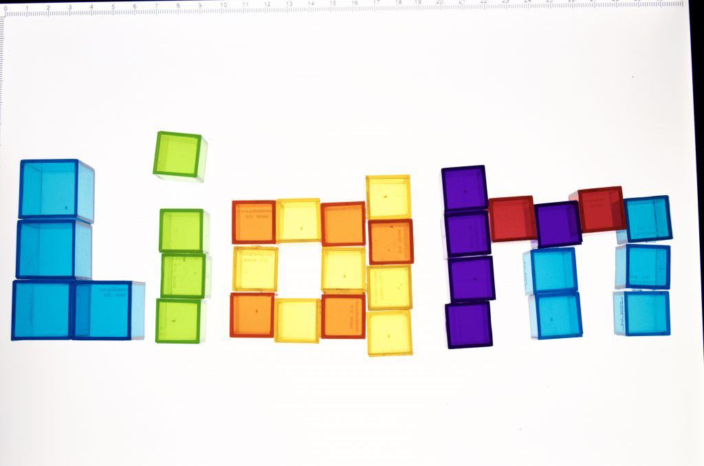 Light Table Spelling Letters with Transparent Cube Counters