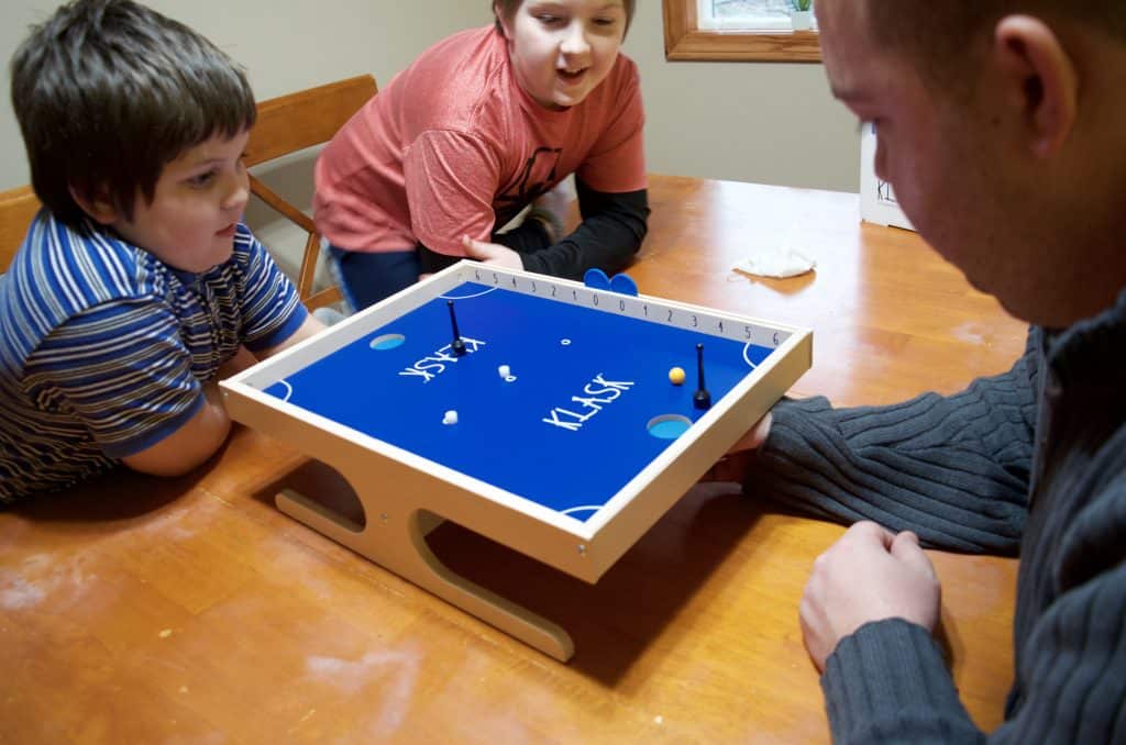 family playing Klask for family game night