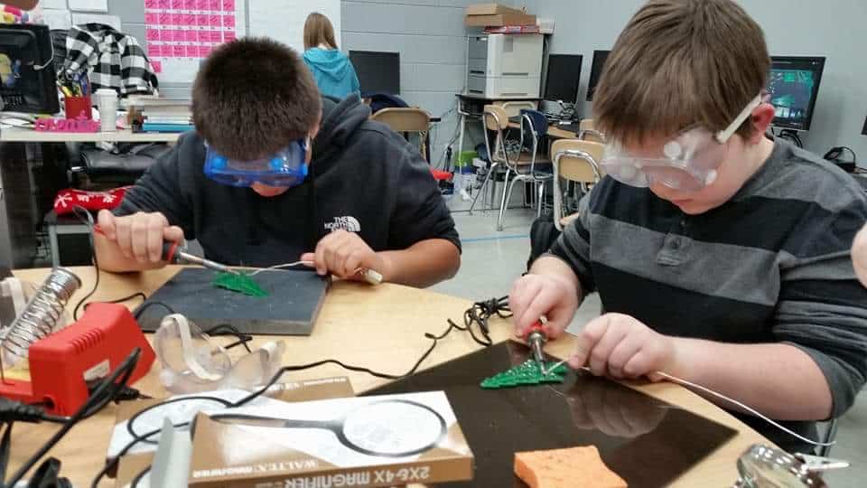 middle school students soldering