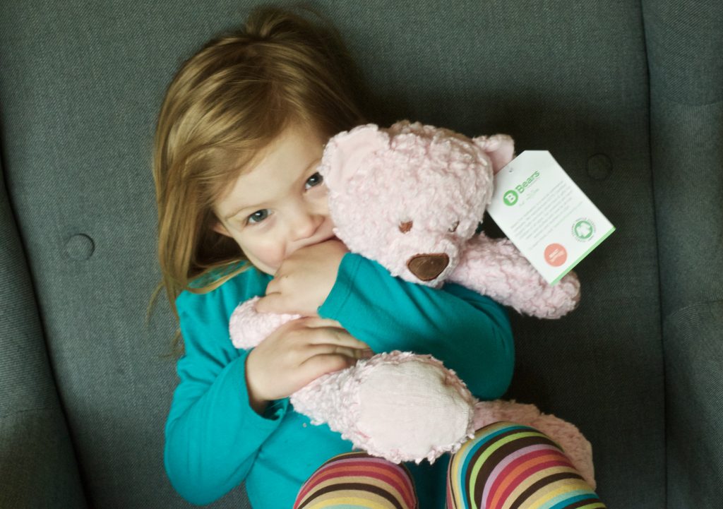 preschool girl hugging pink bear