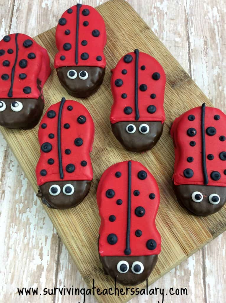 ladybug cookies on wood cutting board