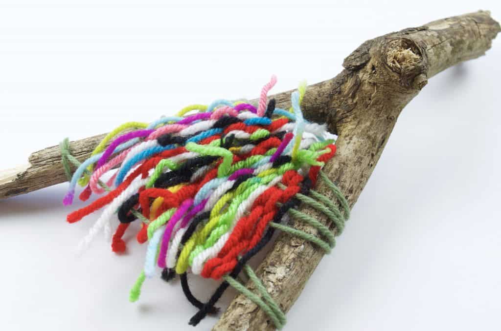 stick with colors of yarn wrapped camping craft