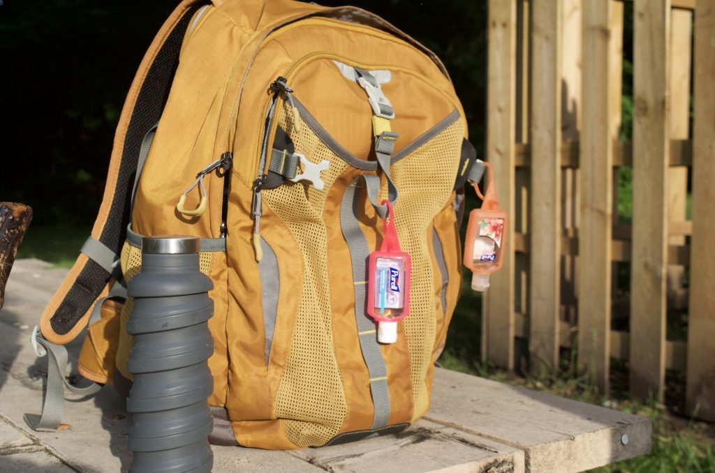 water bottle, backpack and hand sanitizer