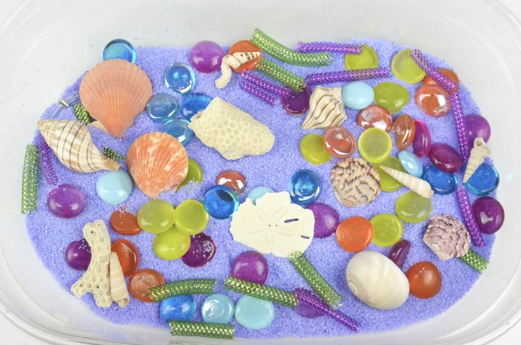 mermaid sensory bin with seashells