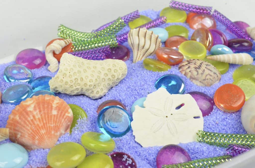 close up of mermaid sensory bin for preschool play