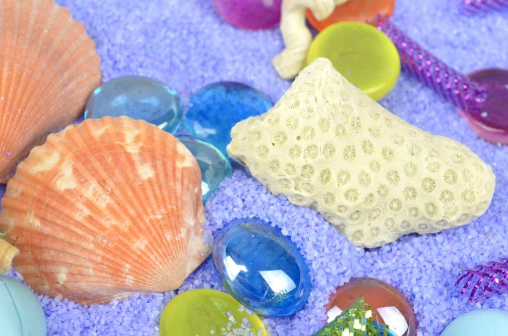 Mermaid Sensory Bin with seashells to play