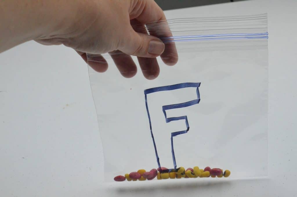 bag with letter F and colored beans for fire safety