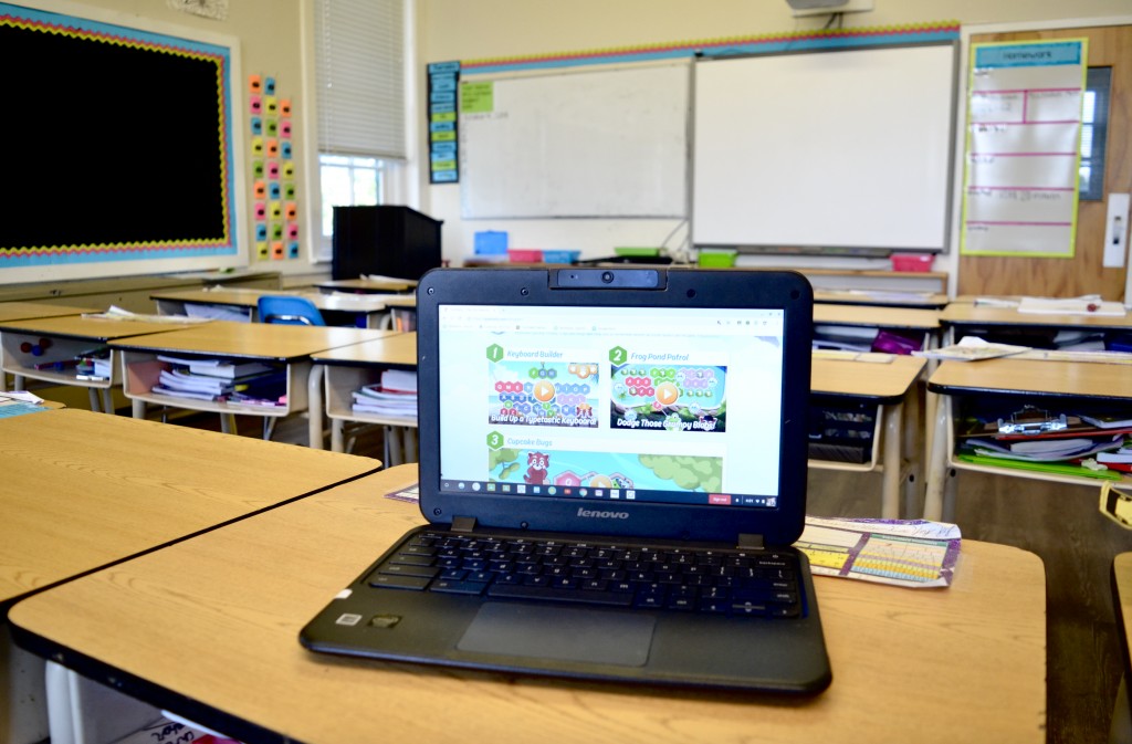 computer typing program on school desk in classroom