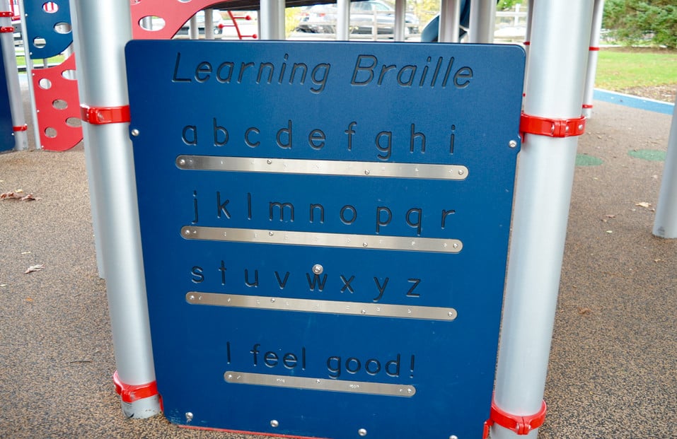 Learning Braille sign on playground