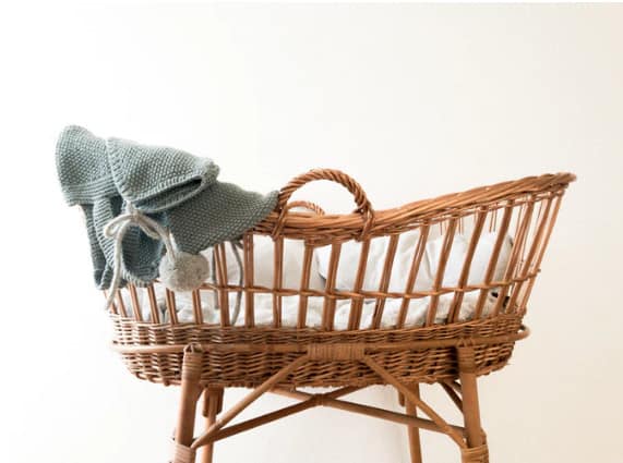 wicker baby crib stock photo