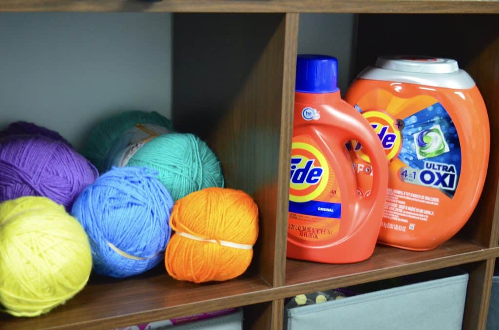 colorful yarn balls and Tide laundry detergent