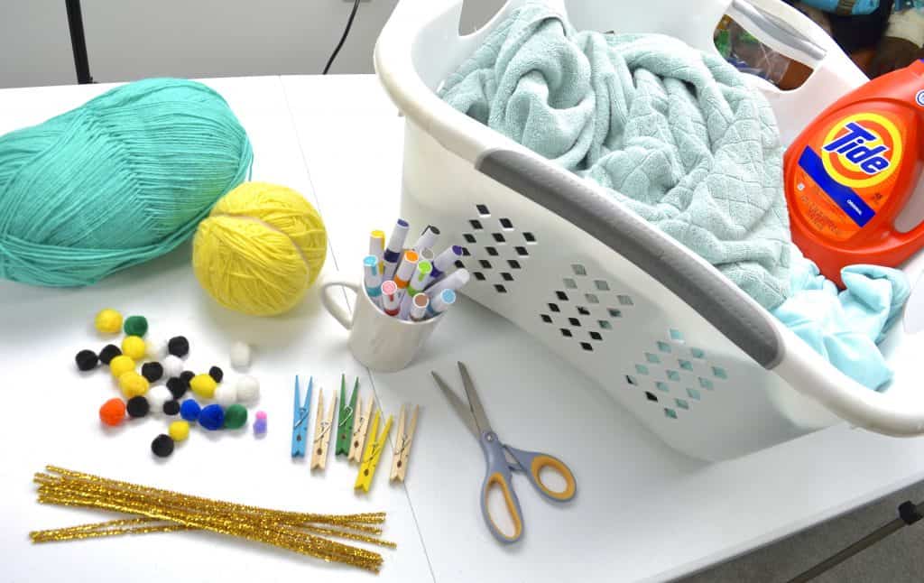 craft supplies next to laundry basket Tide