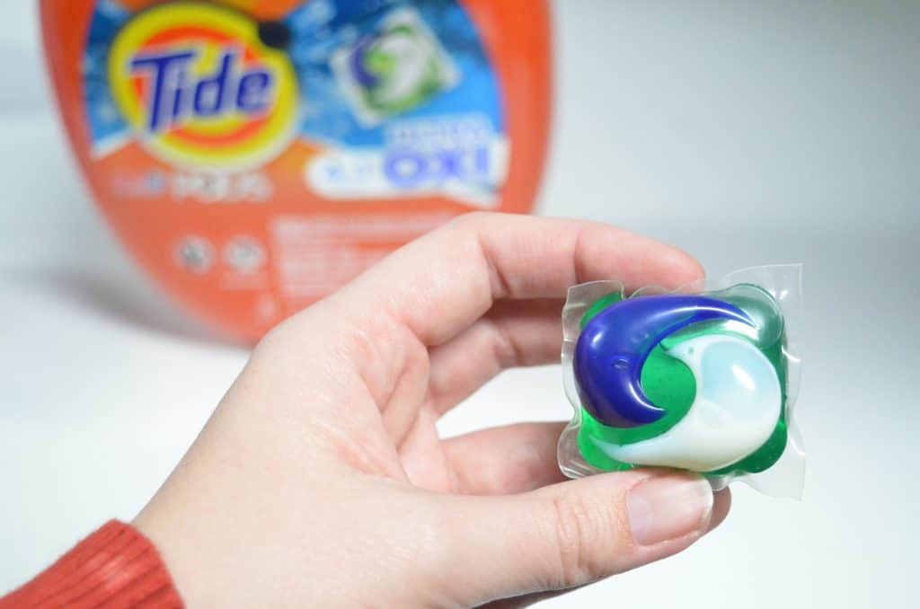 one Tide PODS held by hand