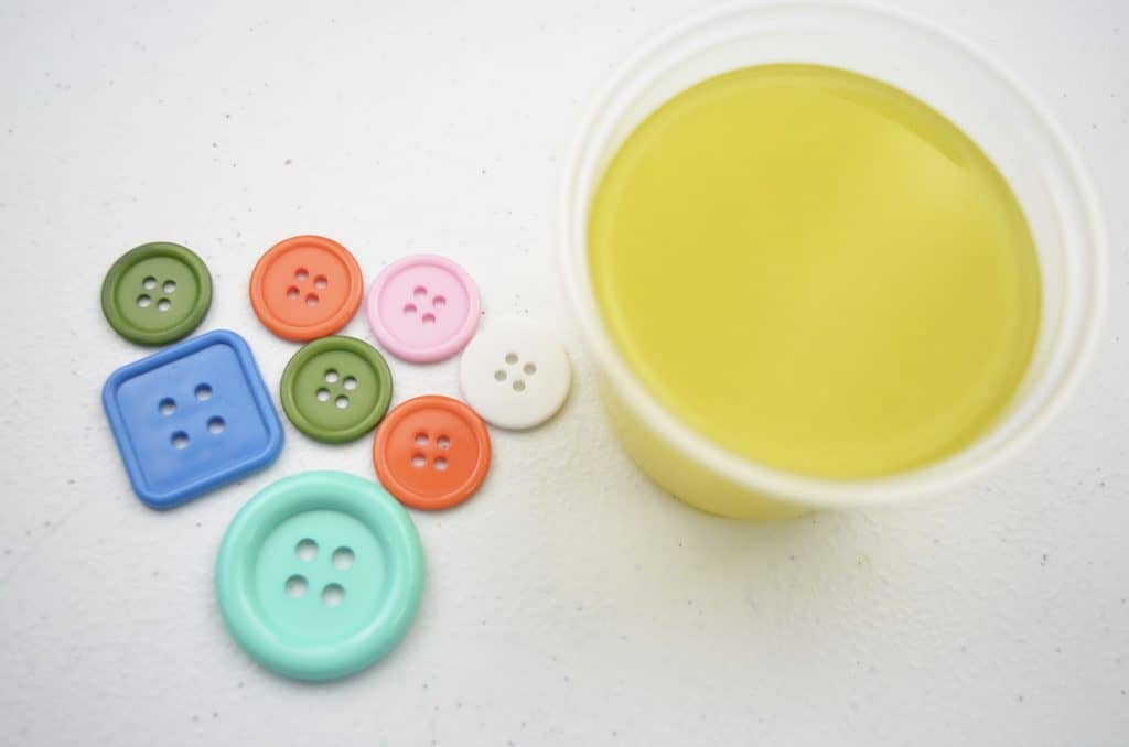 buttons and cup of yellow slime