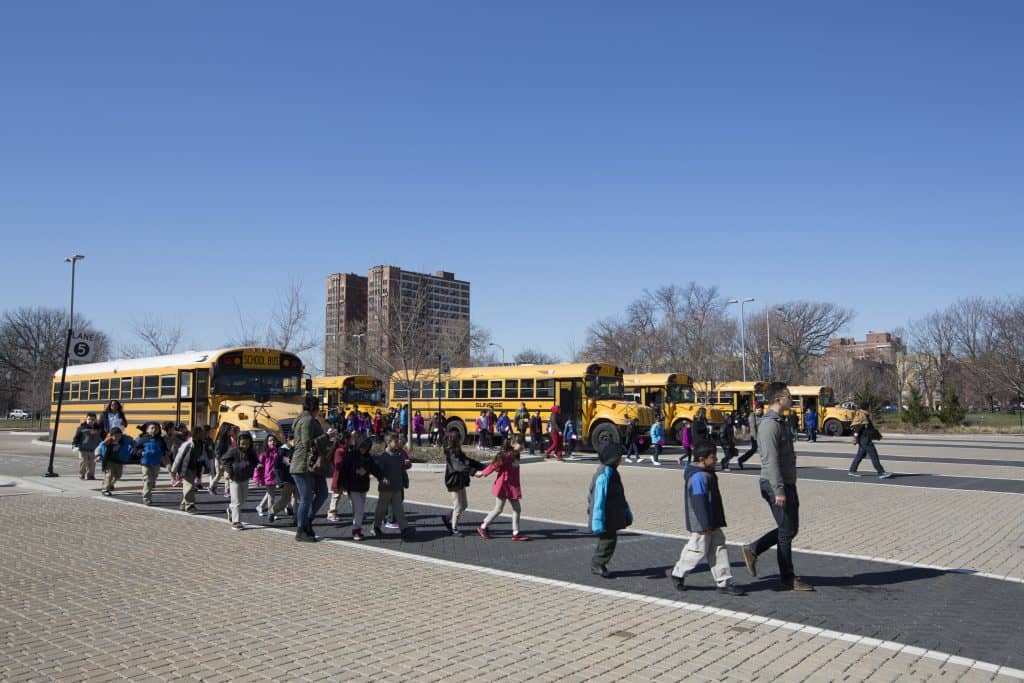 school children in front of school bus