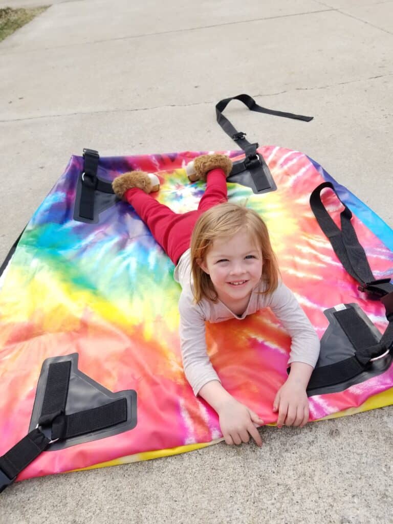 girl on tie dye car top carrier